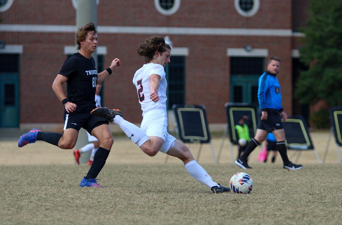 Man tossing soccer ball on field